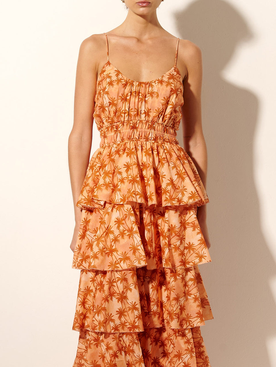Leilani Maxi Dress KIVARI | Model wears bronze and peach palm printed maxi dress close up