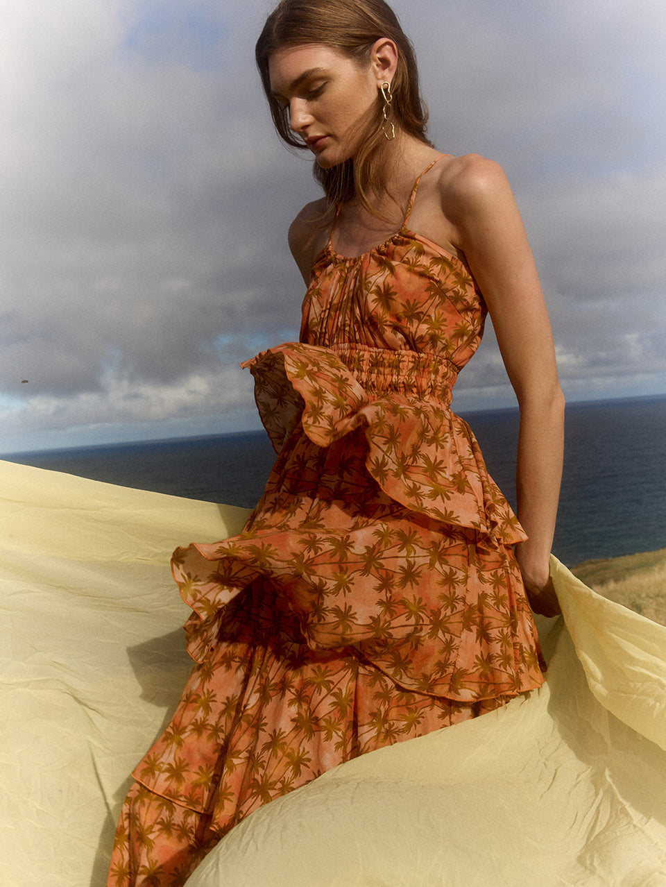 Leilani Maxi Dress KIVARI | Model wears bronze and peach palm printed maxi dress campaign