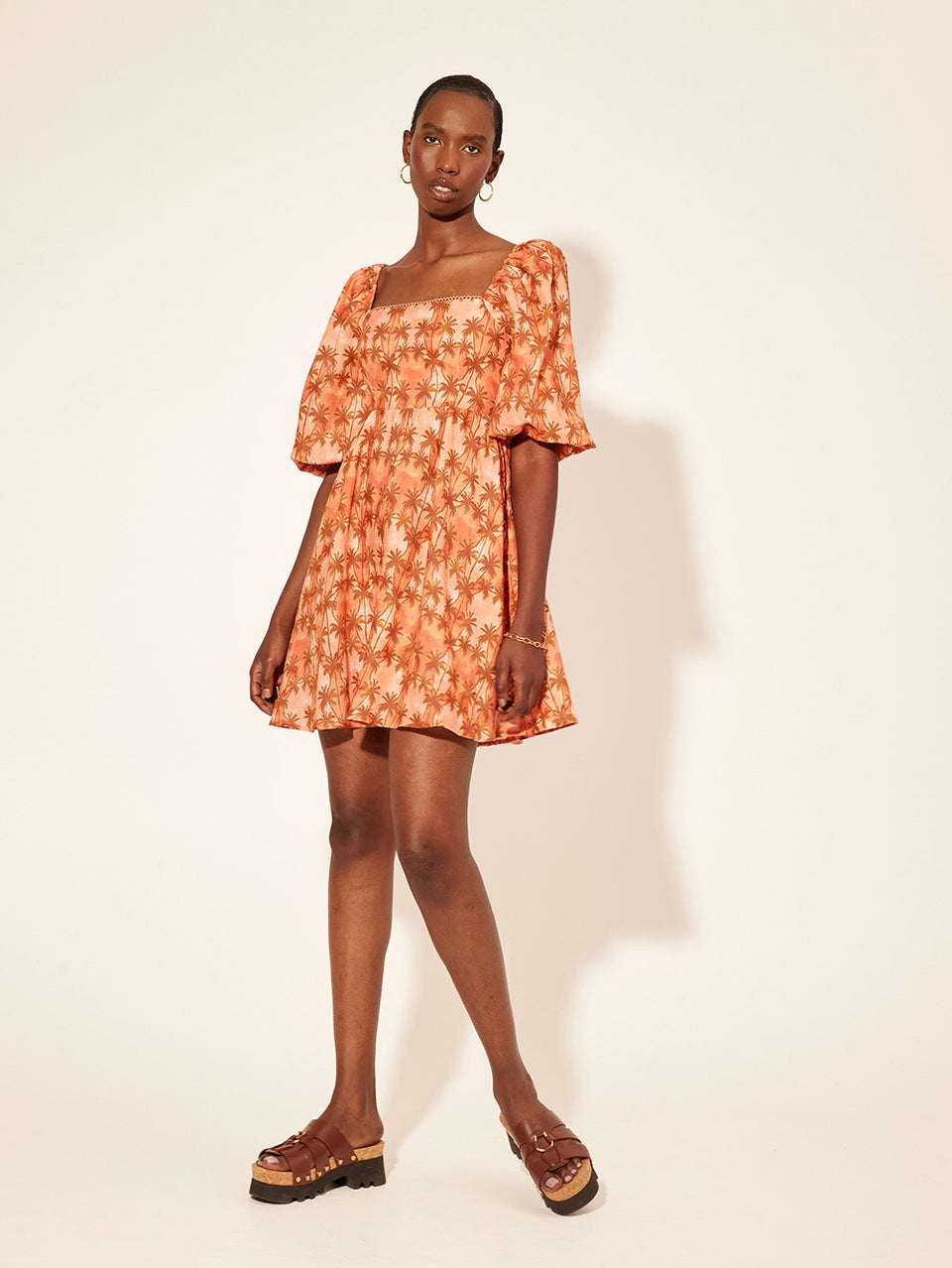 Leilani Mini Dress KIVARI | Model wears bronze and peach palm printed mini dress