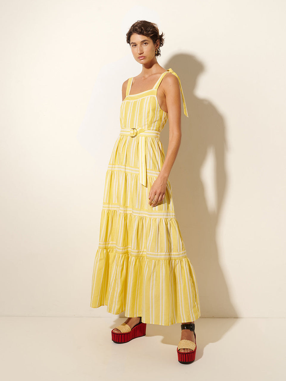 Lola Maxi Dress KIVARI | Model wears yellow and white striped maxi dress side view