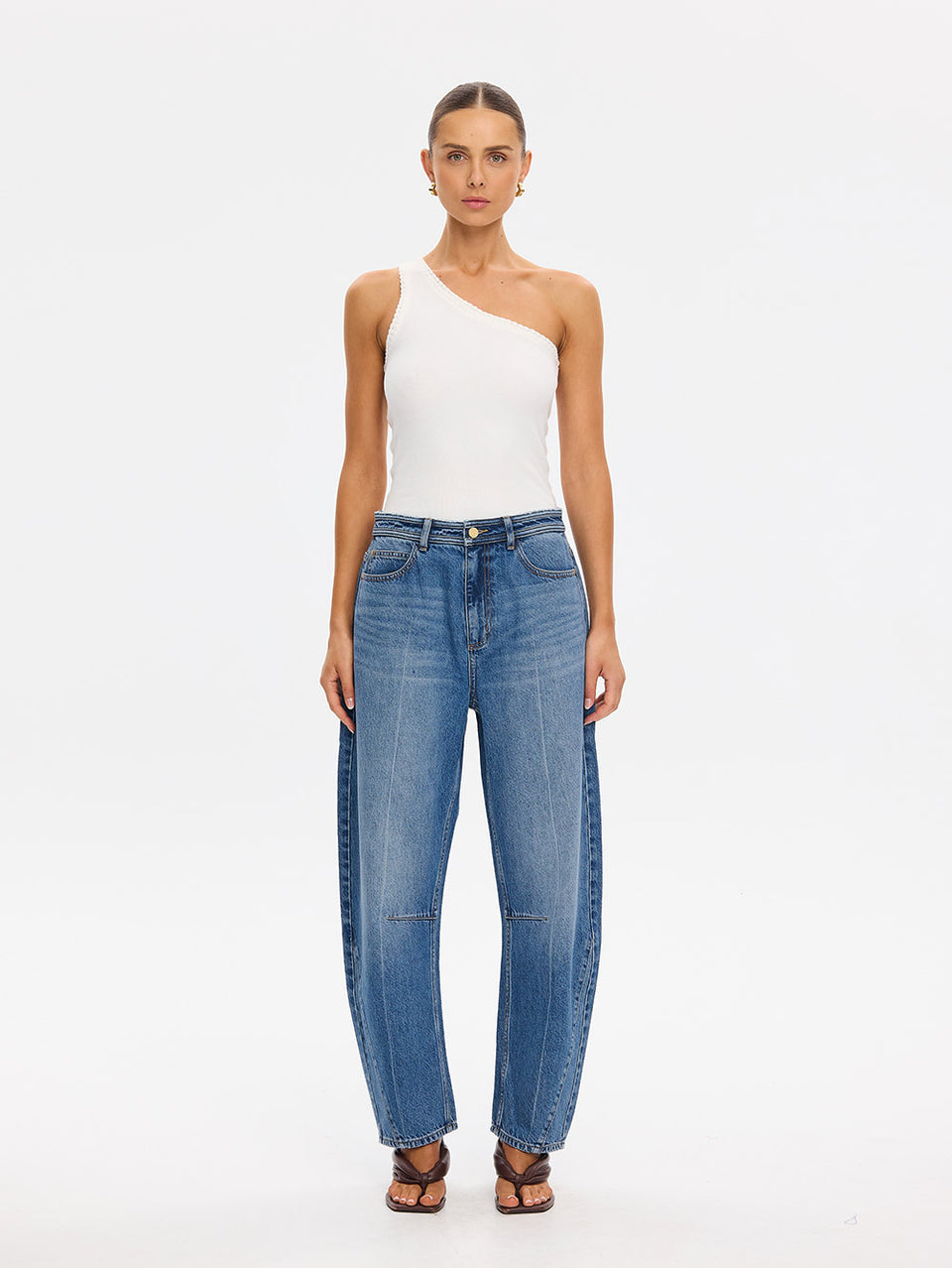 KIVARI Dylan Jeans in Drift Blue – front-facing product photo with white one-shoulder top and sandals