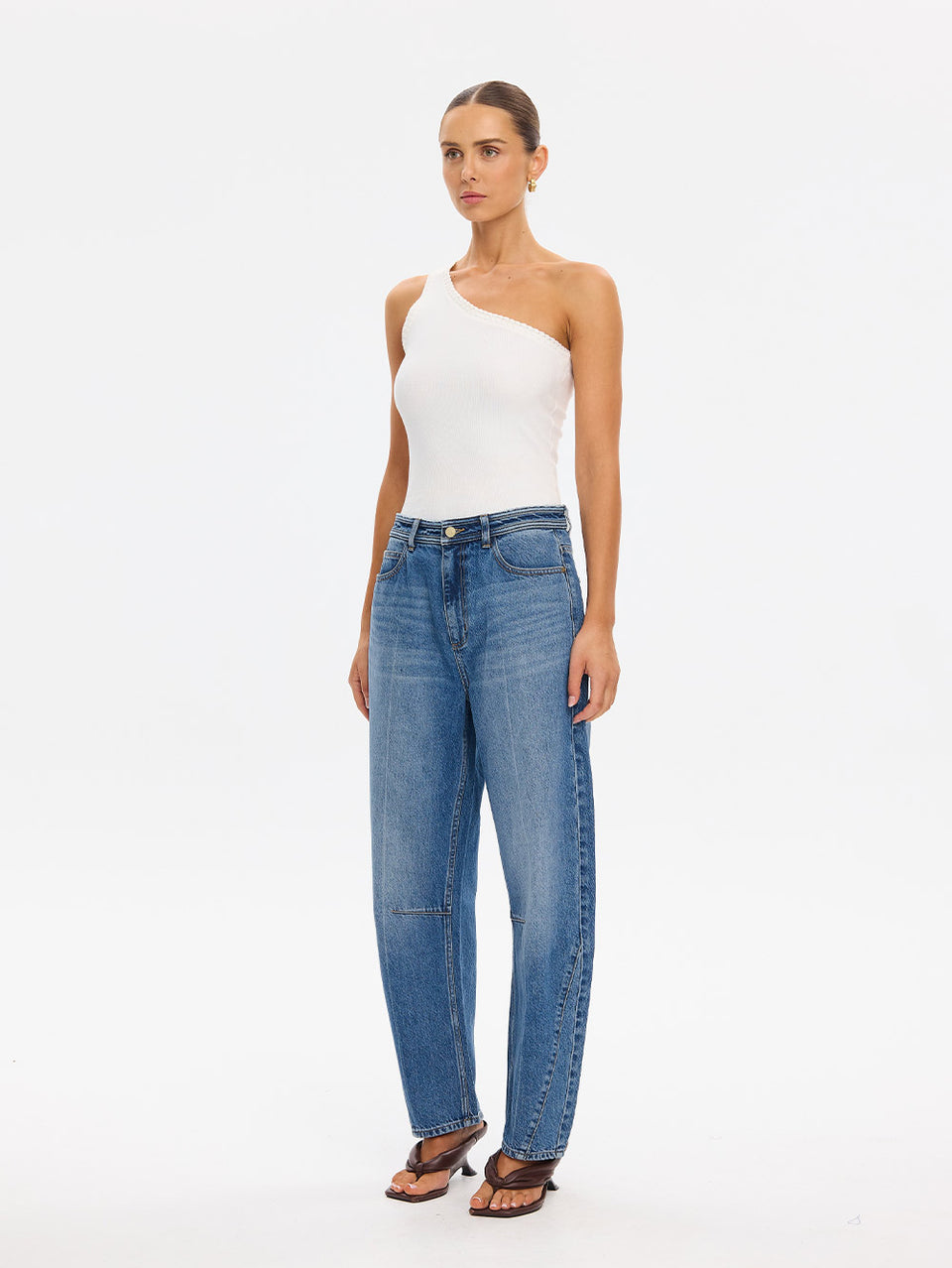 KIVARI Dylan Jeans in Drift Blue – full-length front view with white one-shoulder top and heeled sandals