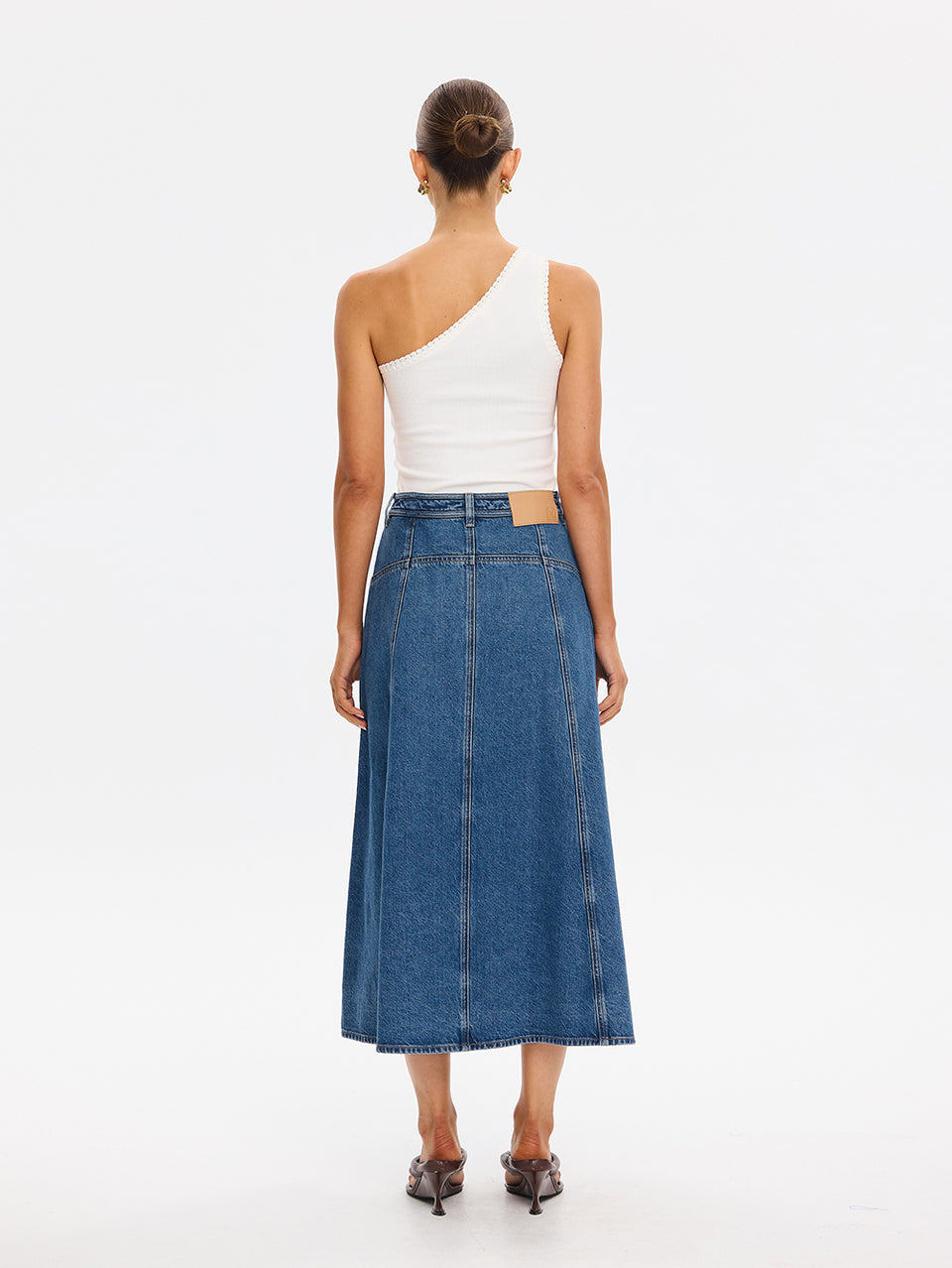 KIVARI Rita Denim Skirt in Drift Blue – back view of A-line midi denim skirt styled with a one-shoulder top