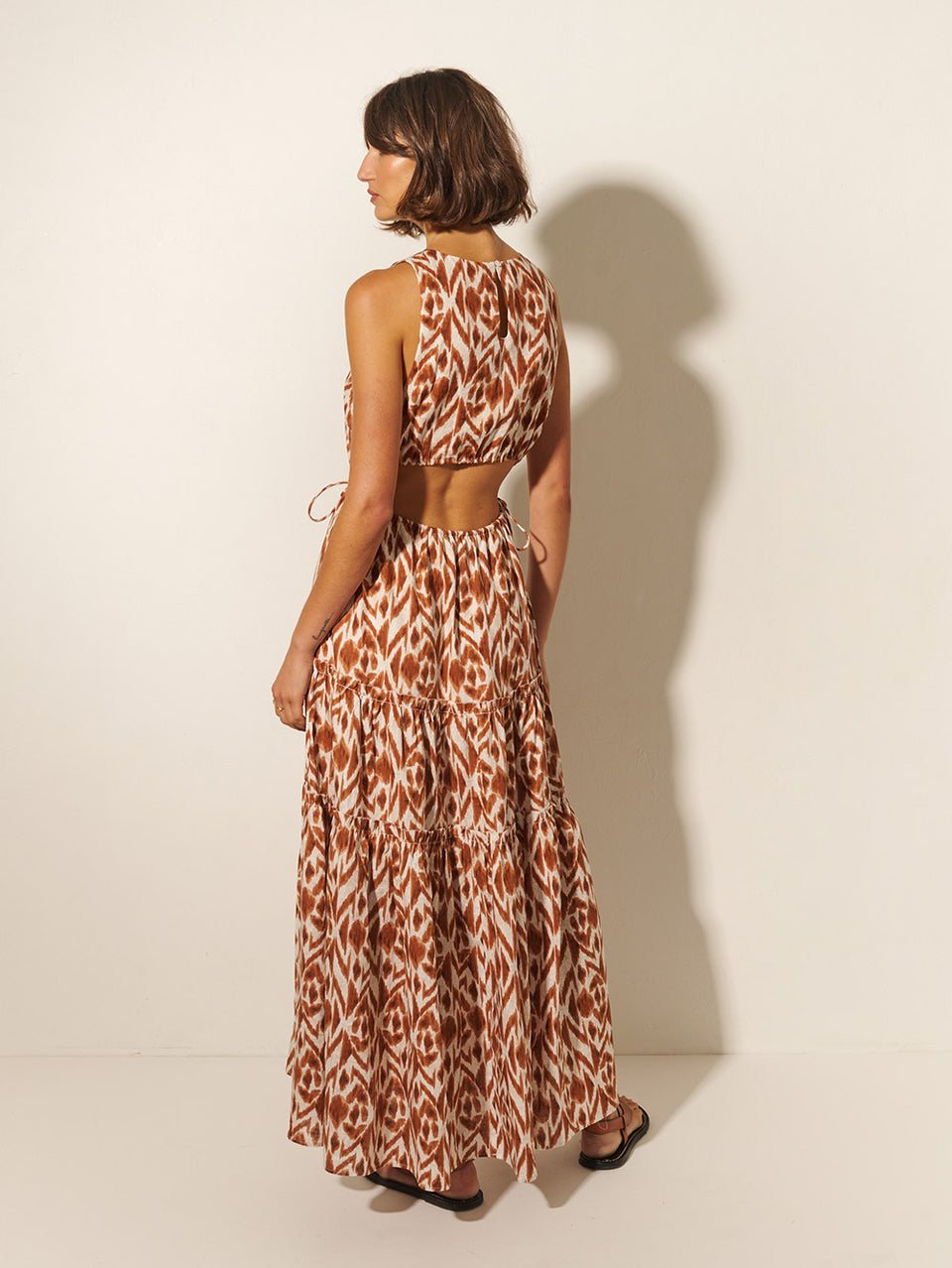 Marisa Cut Out Maxi Dress KIVARI | Model wears brown and ivory aztek printed cut out maxi dress back view