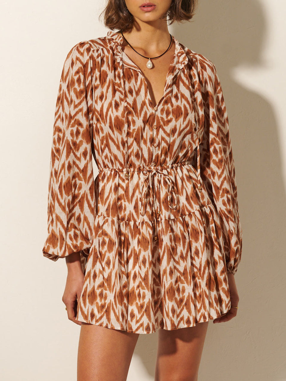 Marisa Mini Dress KIVARI | Model wears brown and ivory aztek printed mini dress close up