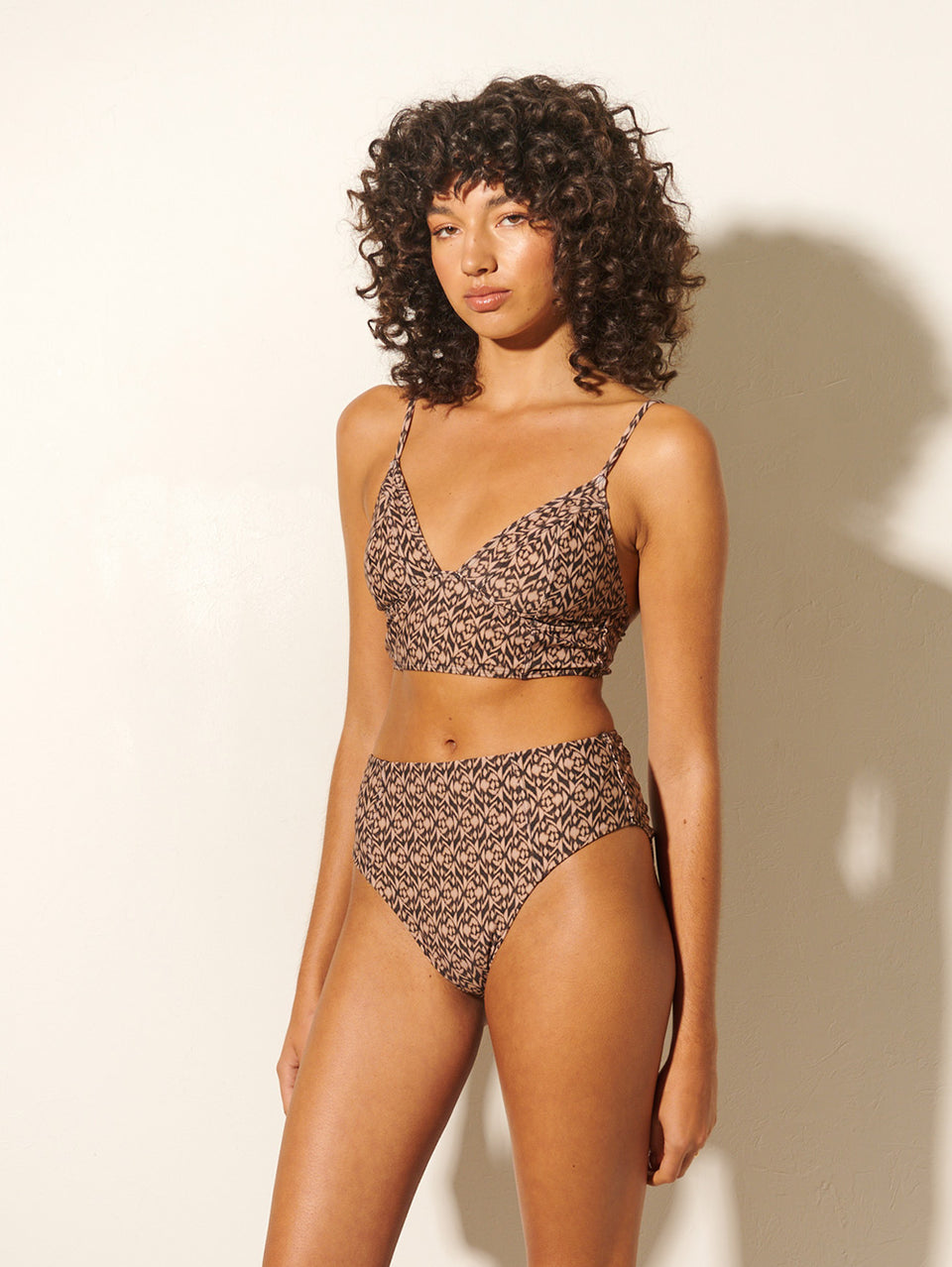 Marisa Panelled Bikini Bottom KIVARI | Model wears brown and ivory aztek printed bikini bottoms side view