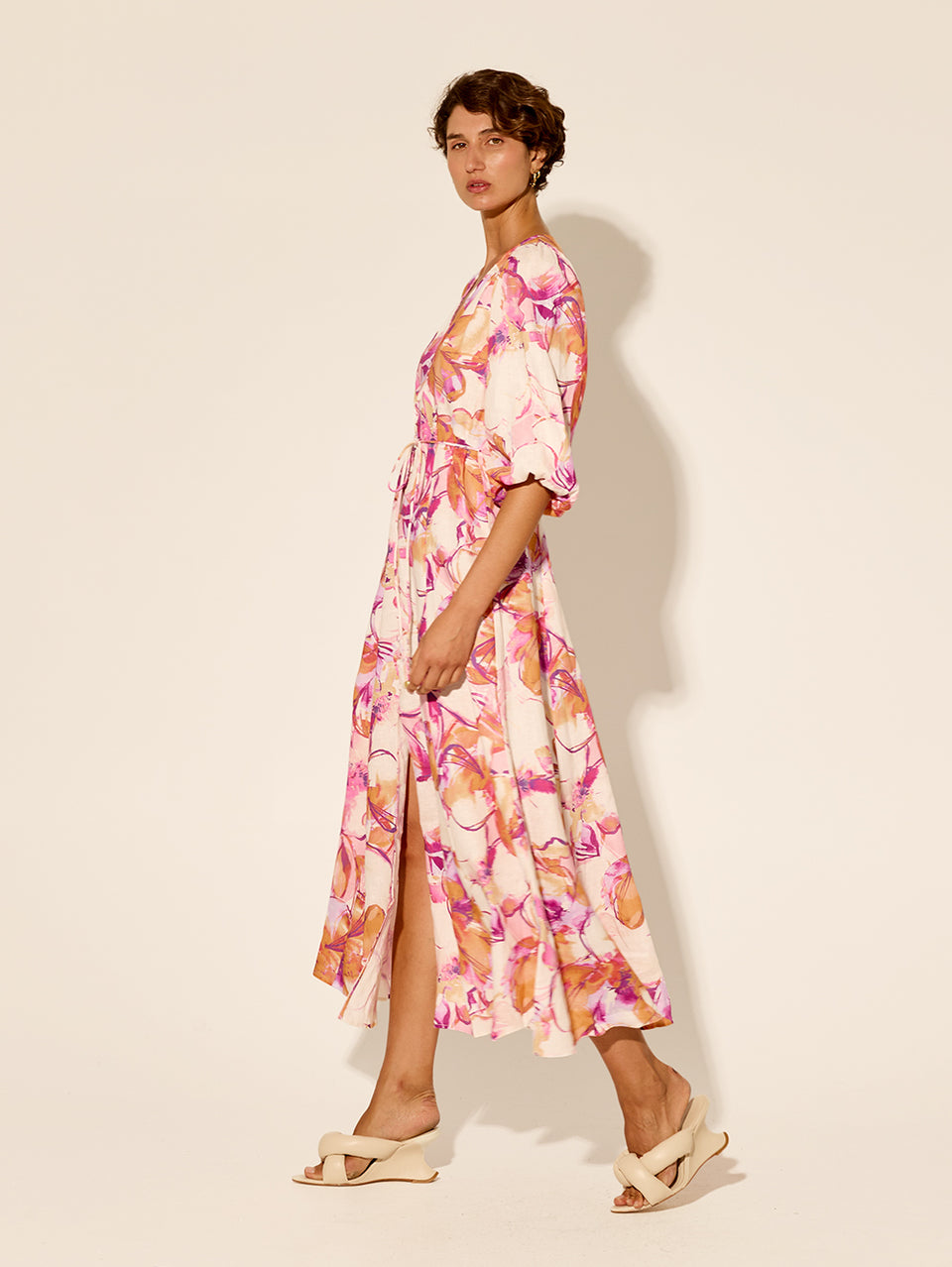 Nadia Maxi Dress KIVARI | Model wears pink and orange watercolour floral maxi dress side view