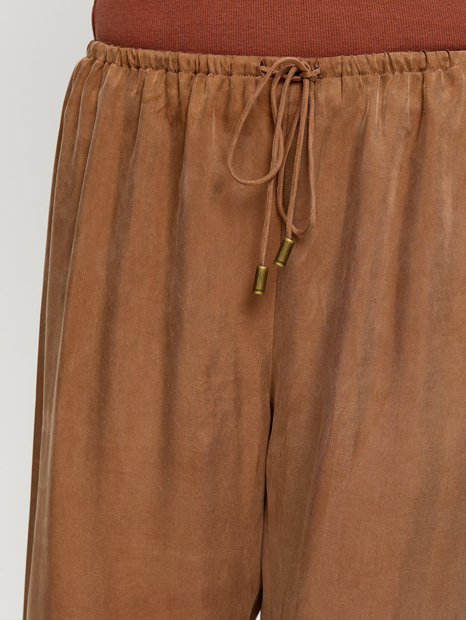 Brown drawstring pants on a white background