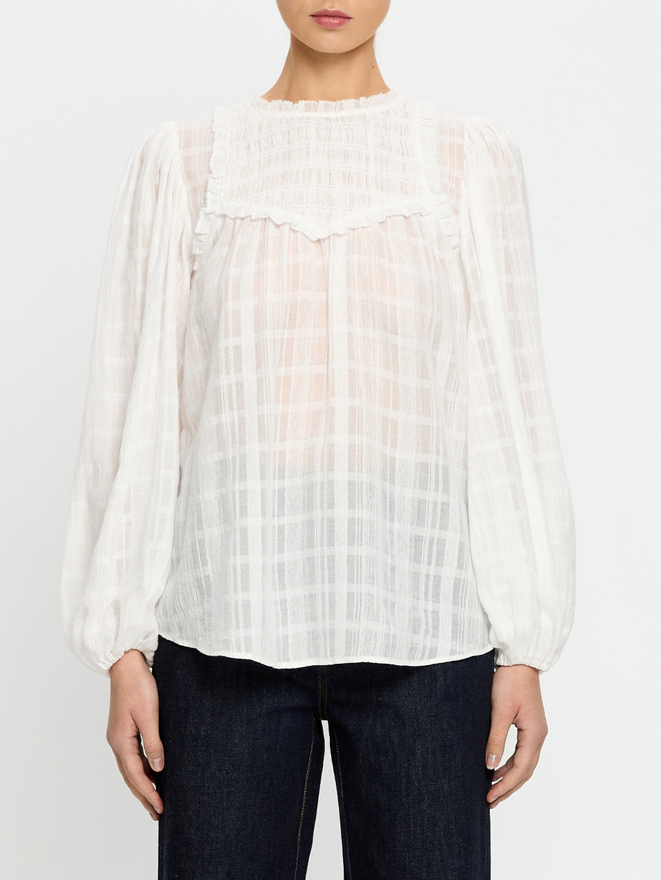 White checkered blouse worn by a person on a white background