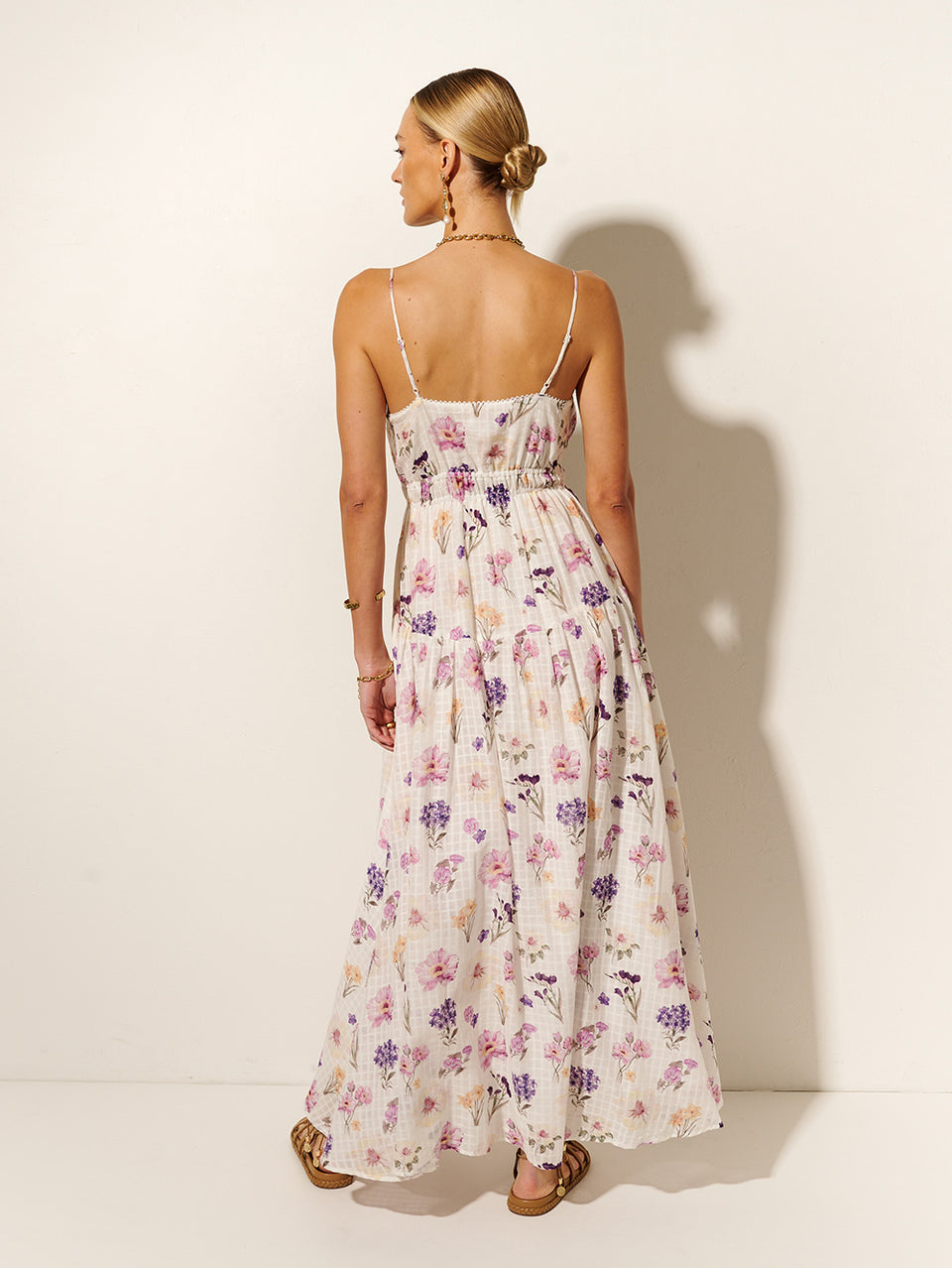 Phoebe Maxi Dress KIVARI | Model wears ivory and purple floral maxi dress back view