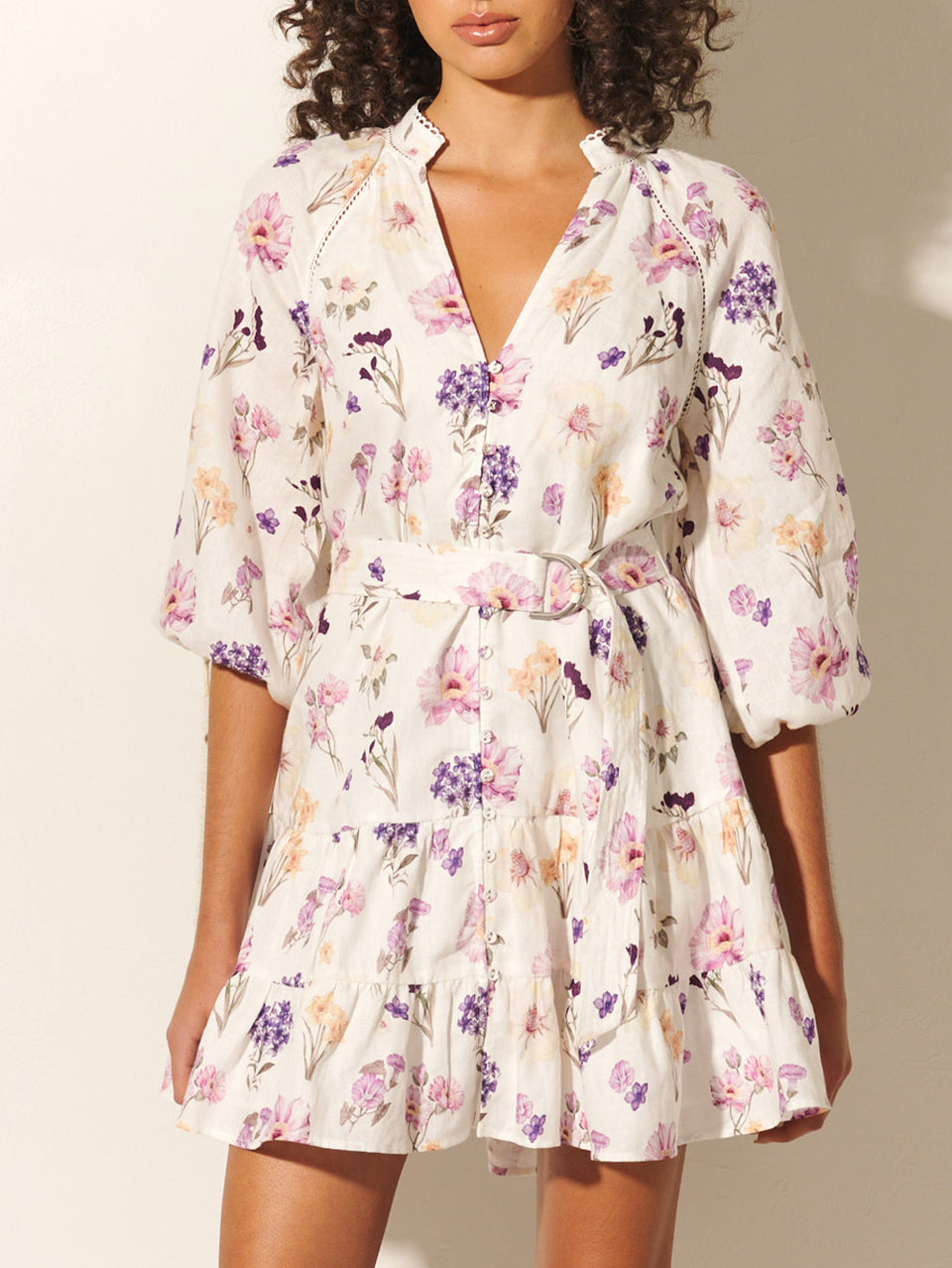 Phoebe Mini Dress KIVARI | Model wears ivory and purple floral mini dress close up