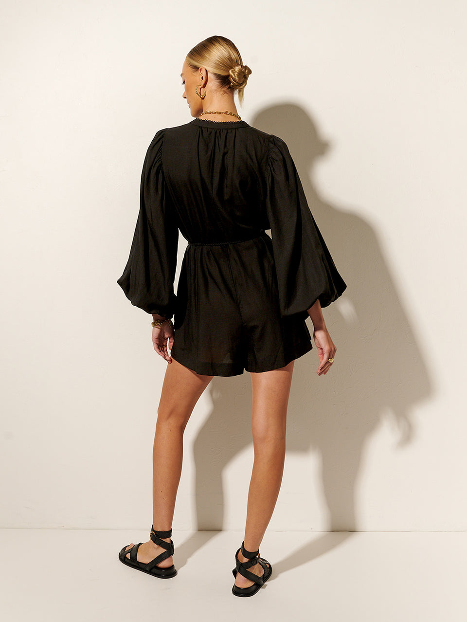 Raquelle Playsuit KIVARI | Model wears black long sleeve playsuit back view