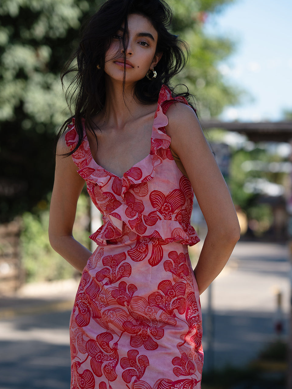 Woman in pink and red floral dress