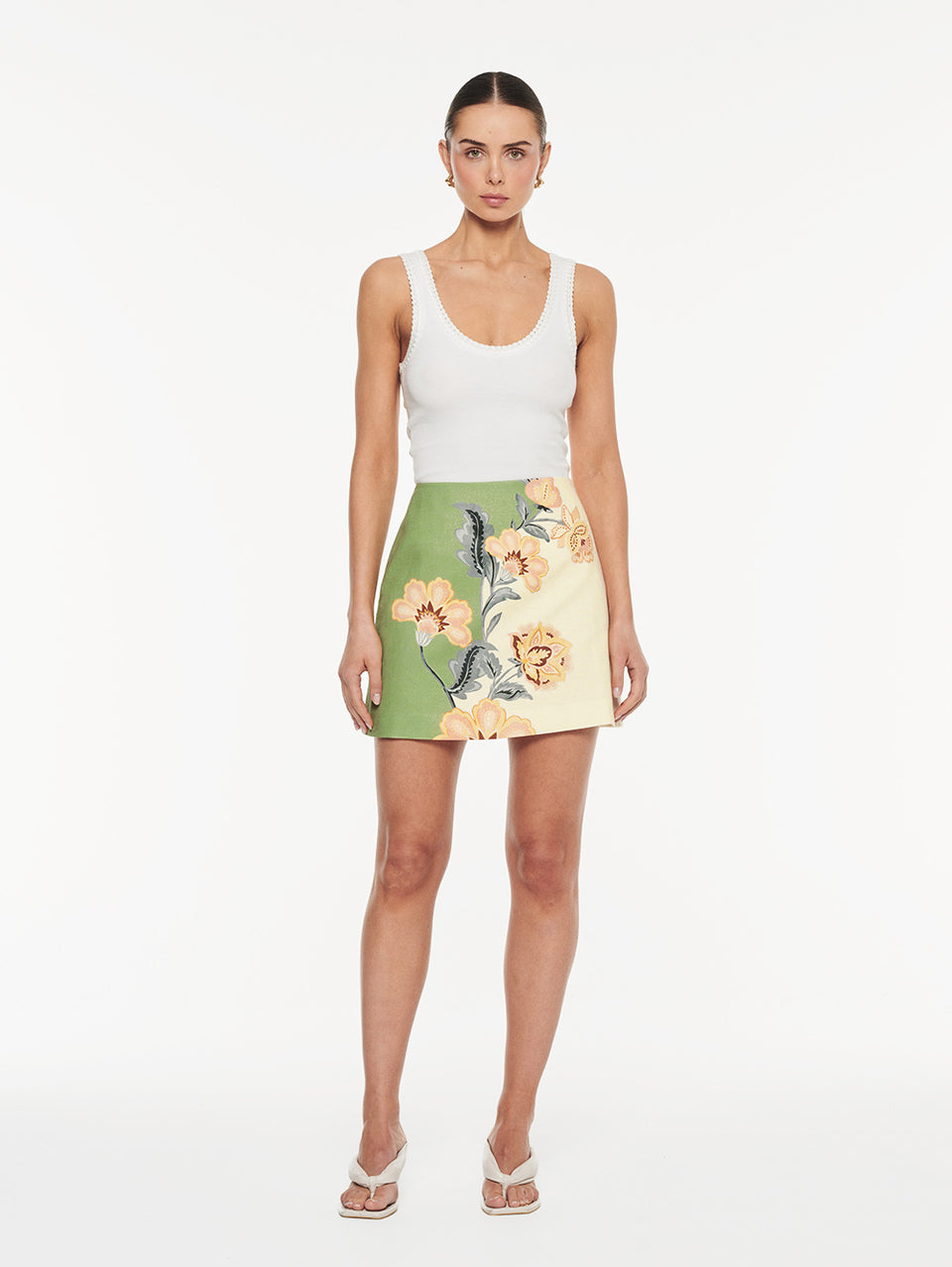 Lotte Mini Skirt in Green Cream, front view of A-line mini skirt with floral print and white tank top