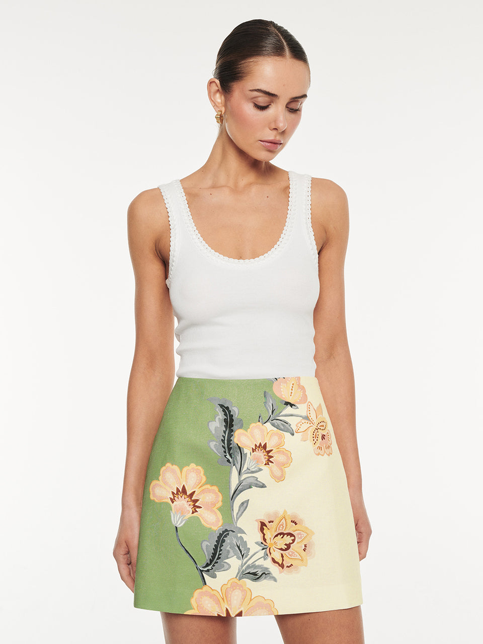 Lotte Mini Skirt in Green Cream, high-waisted A-line mini skirt with floral print, styled with white tank top