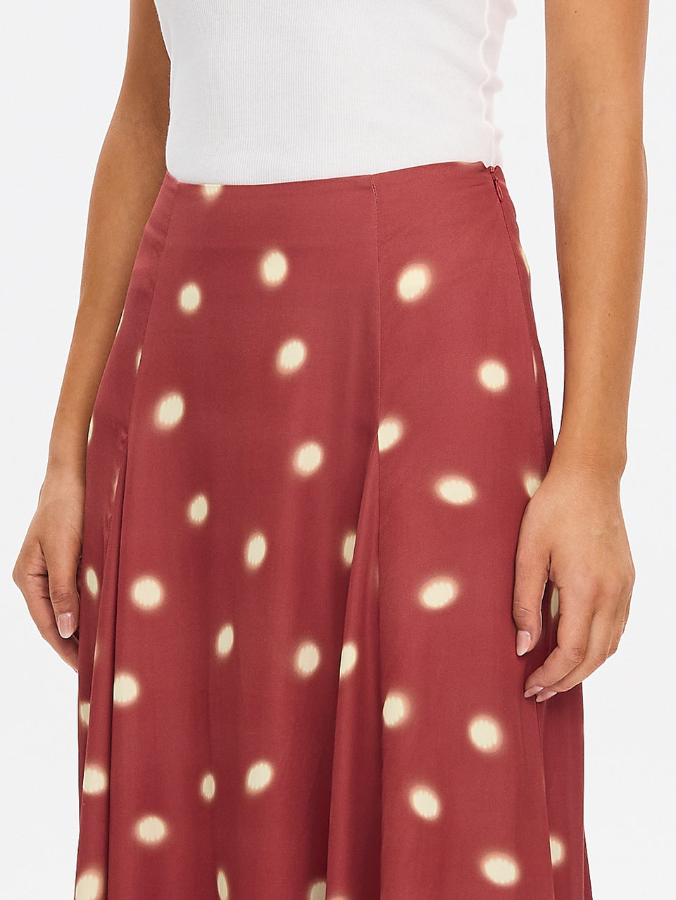 KIVARI Saro Maxi Skirt in Brick – close-up of polka dot fabric detail on flowing maxi skirt