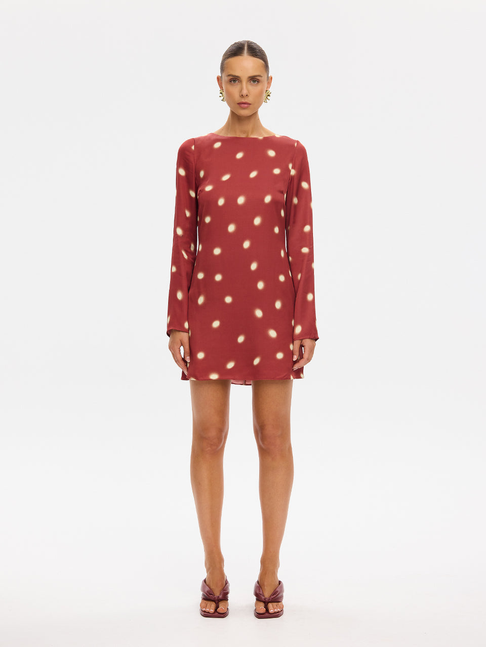 KIVARI Saro Mini Dress in Brick – long-sleeve polka dot mini dress, front view on model