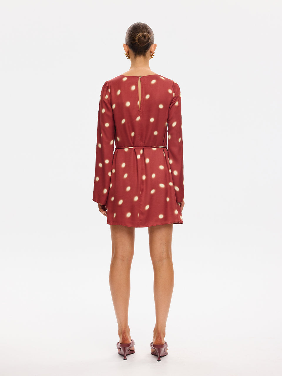 KIVARI Saro Mini Dress in Brick – back view of long-sleeve polka dot mini dress with tie waist