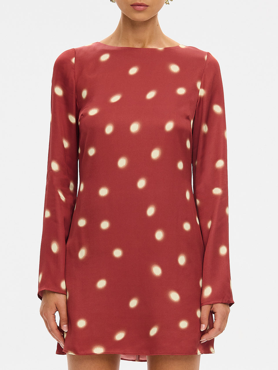 KIVARI Saro Mini Dress in Brick – close-up front view of long-sleeve polka dot mini dress