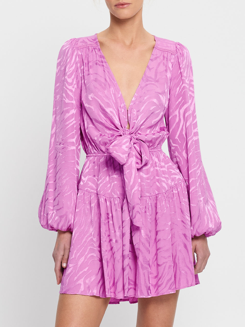 Stela Tie Front Mini Dress KIVARI | Model wears pink zebra print mini dress close up