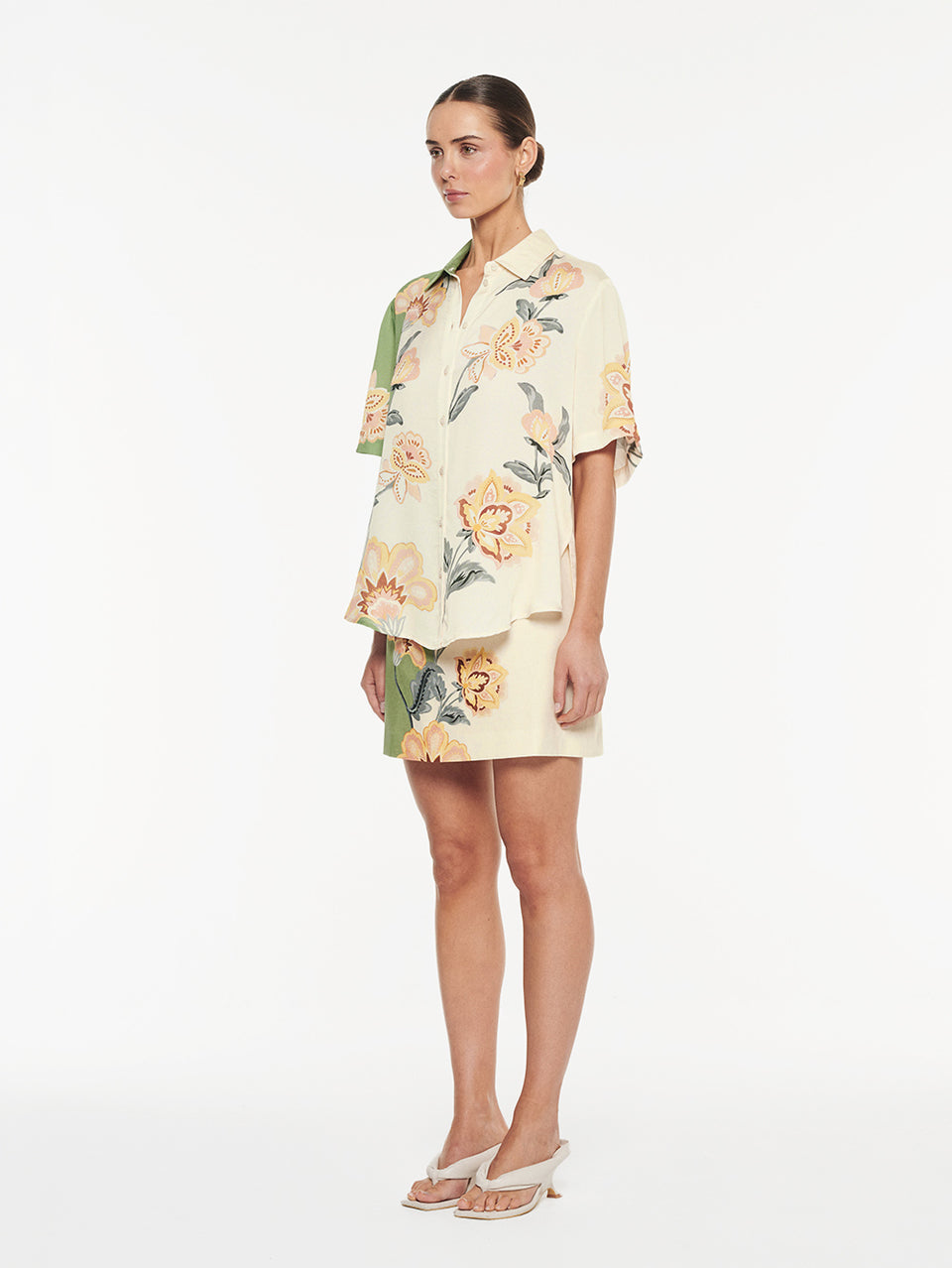 Lotte Shirt in Green Cream, matching two-piece floral print shirt and mini skirt set, angled view