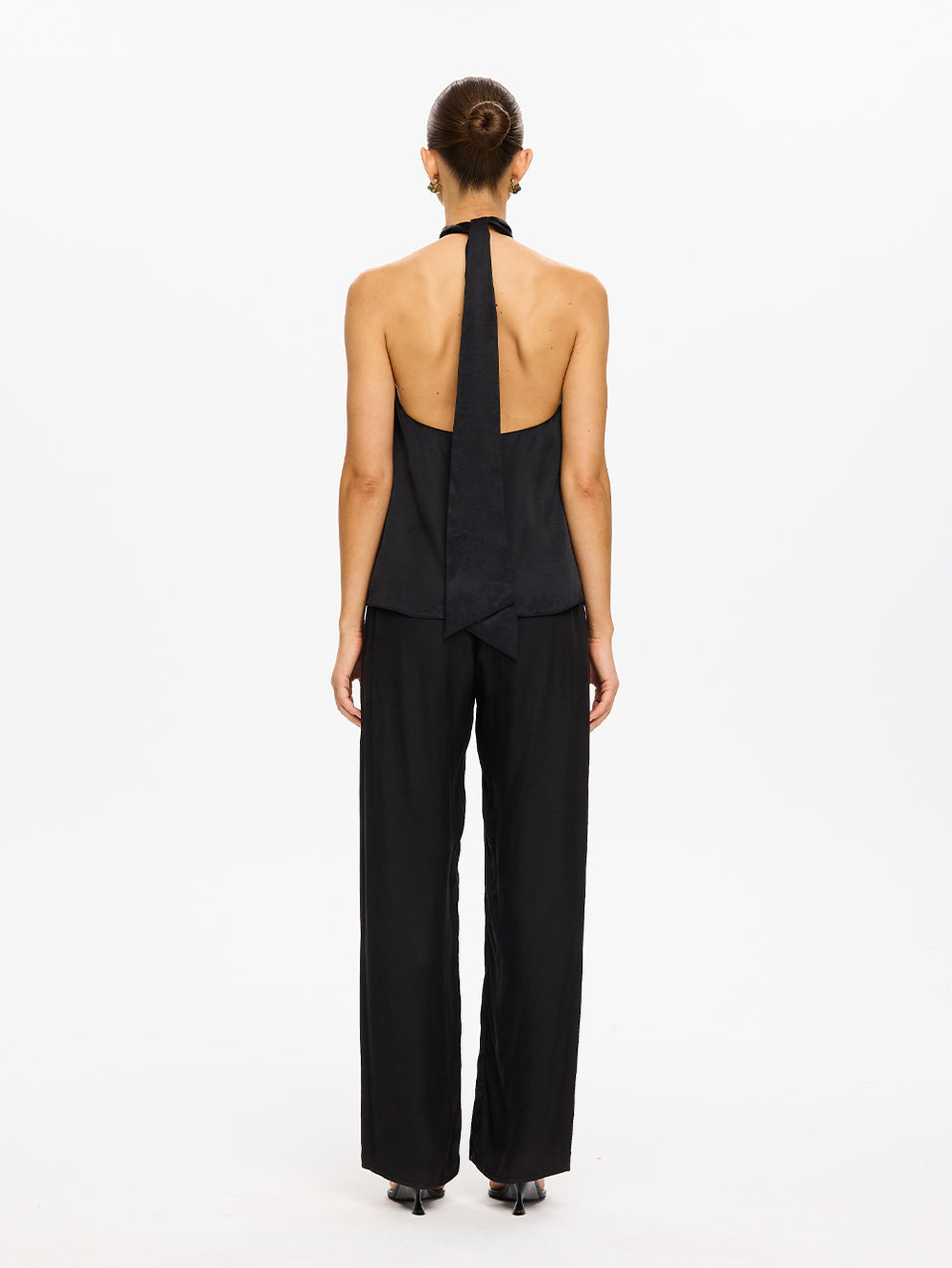 KIVARI Jaxon Halter Top in Black – back view showing open back and halter tie, model wearing women's black halter top with wide-leg pants