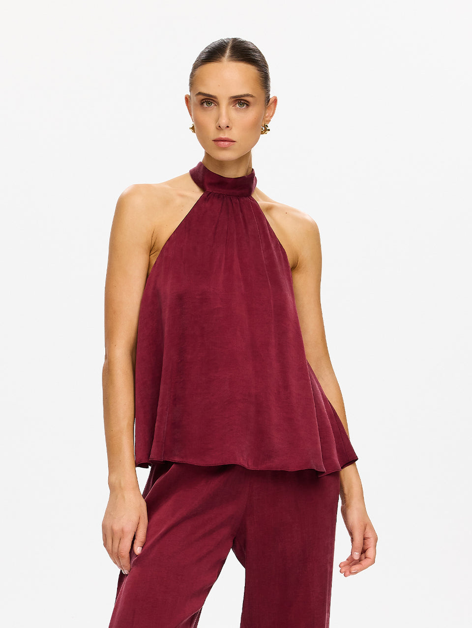 KIVARI Jaxon Halter Top in Plum – three-quarter front view of model wearing women's plum halter neck top with matching wide-leg pants