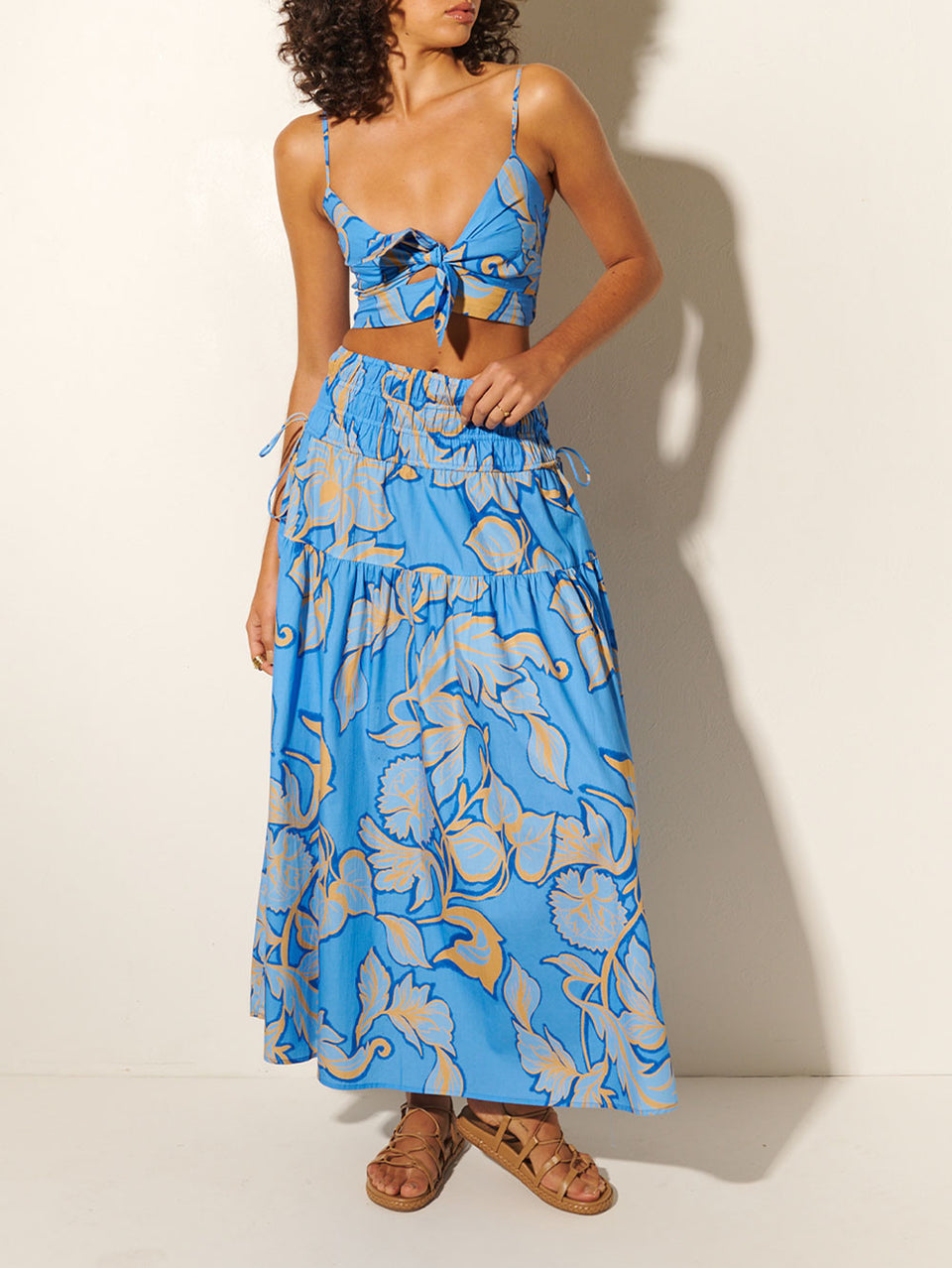 Taniana Maxi Skirt KIVARI | Model wears blue and orange floral maxi skirt with matching crop top 