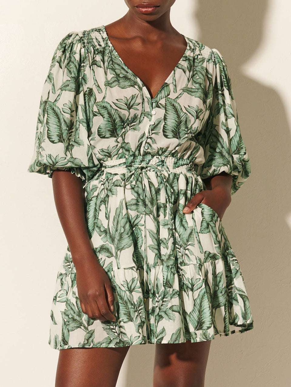 Tropico Mini Dress KIVARI | Model wears palm leaf printed mini dress close up
