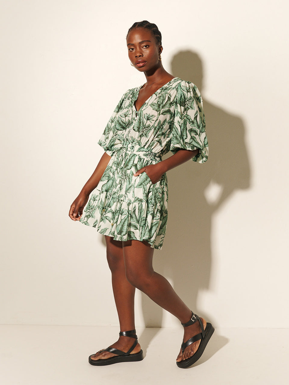 Tropico Mini Dress KIVARI | Model wears palm leaf printed mini dress side view