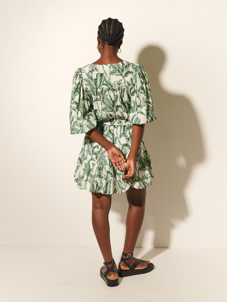 Tropico Mini Dress KIVARI | Model wears palm leaf printed mini dress back view