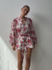Model wearing Red floral playsuit